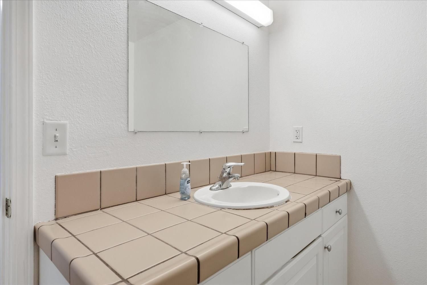 Before: original large vanity with the brown tile