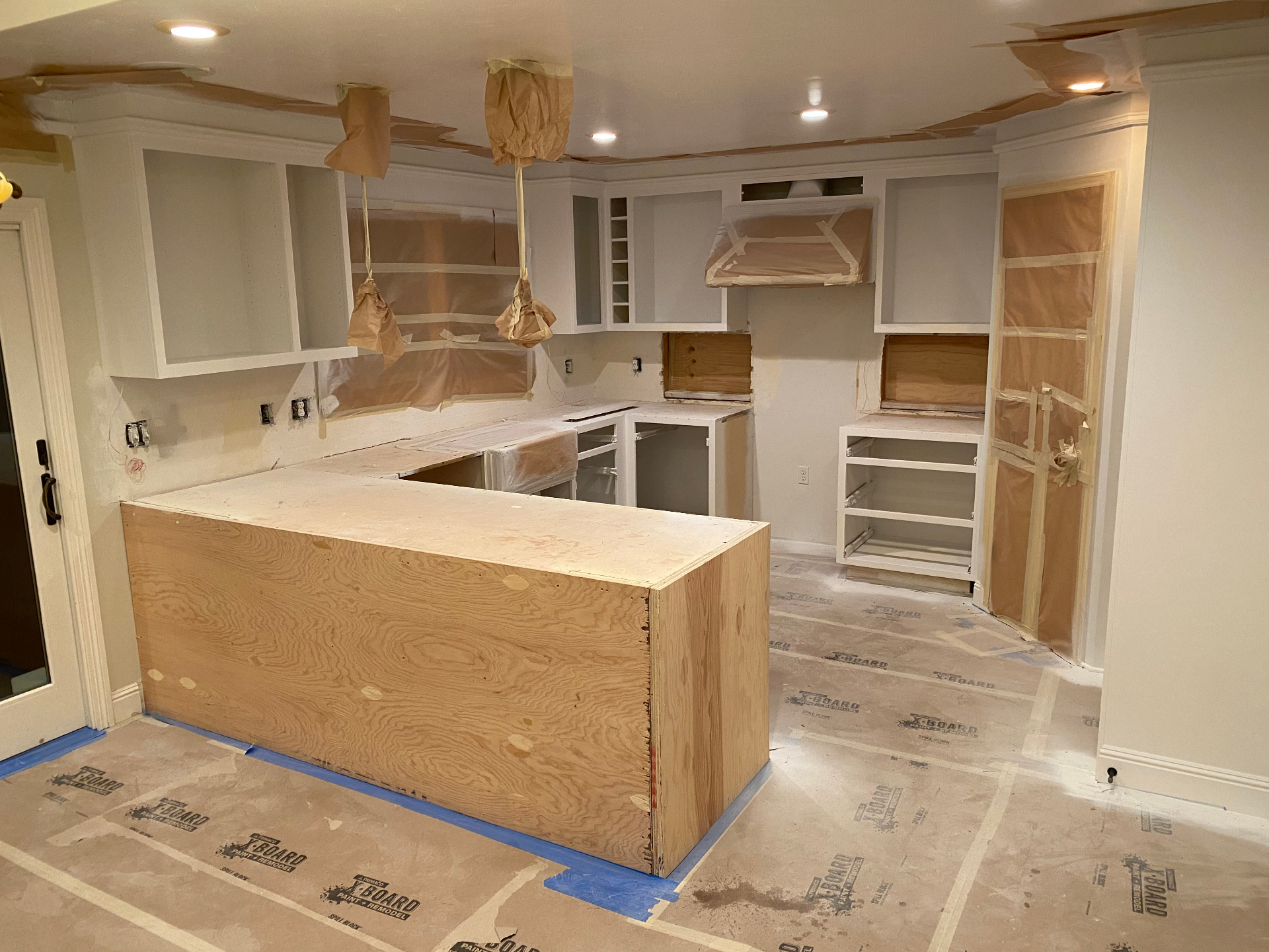 White shaker kitchen prepped for paint before final finishes