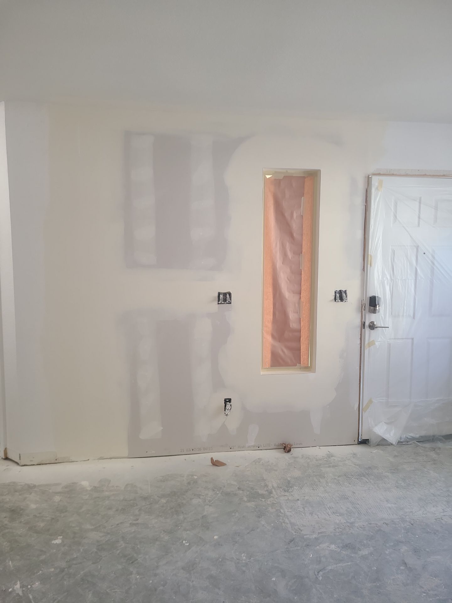 Construction: same wall after drywall has been installed and taped