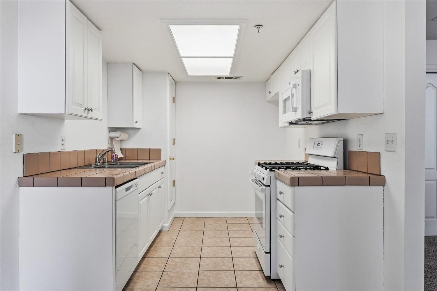 Before: original kitchen with the brown tile