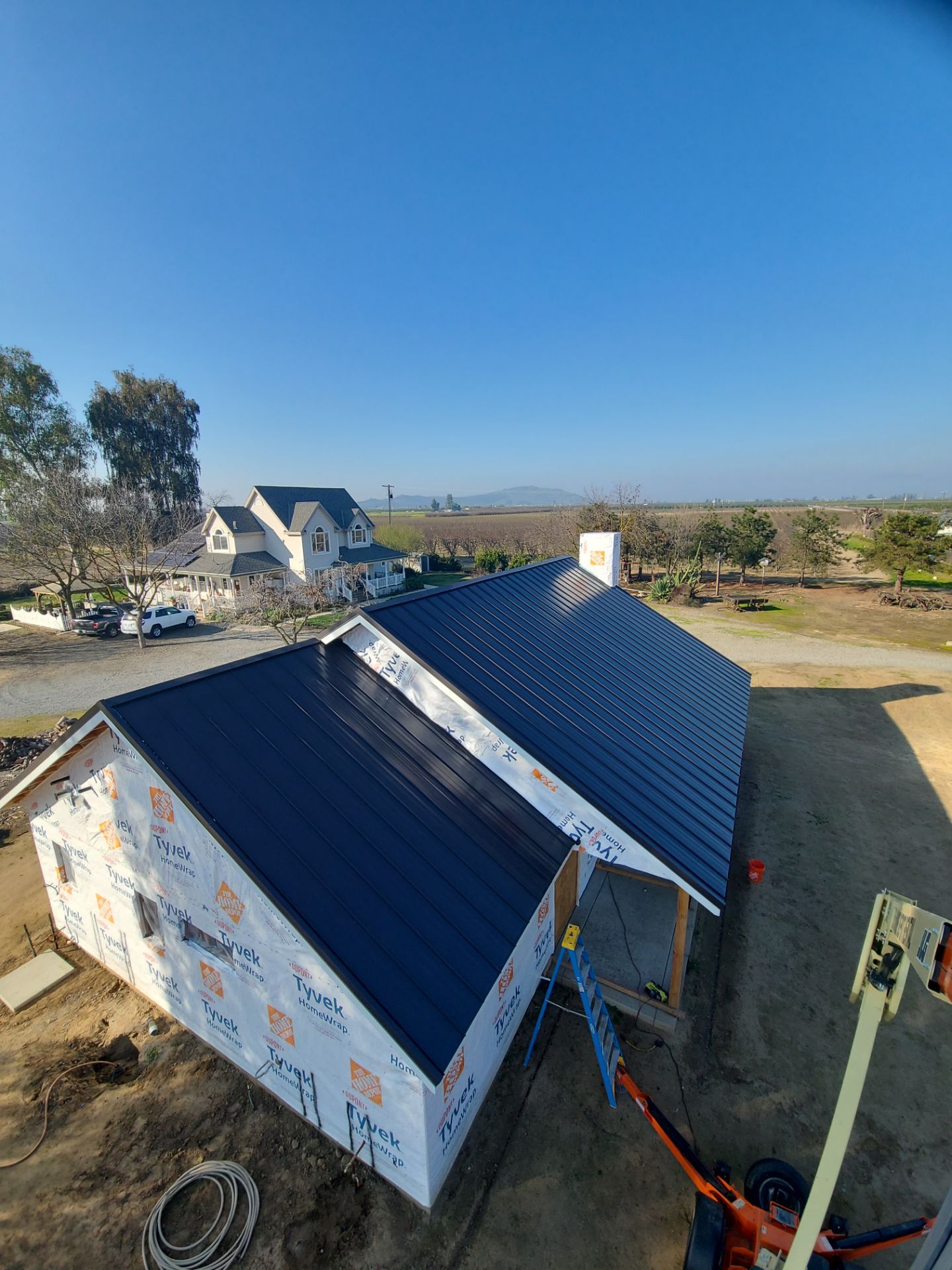 Standing seam metal roof and house wrap installed