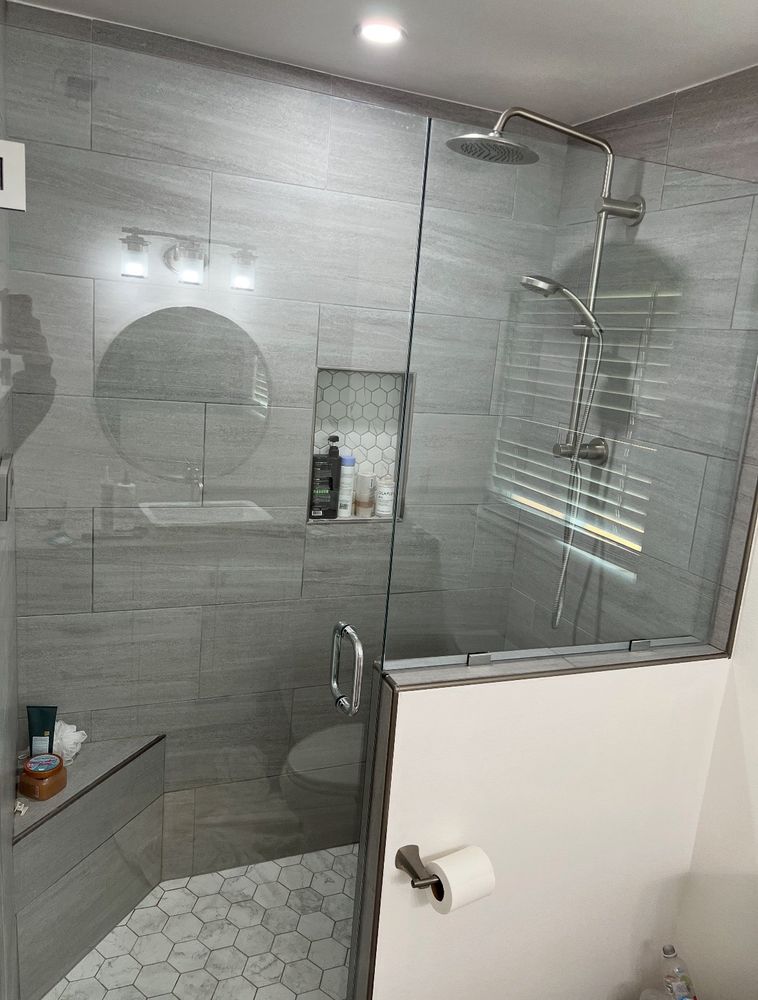 Ruby's finished walk-in shower with frameless glass and gray tile