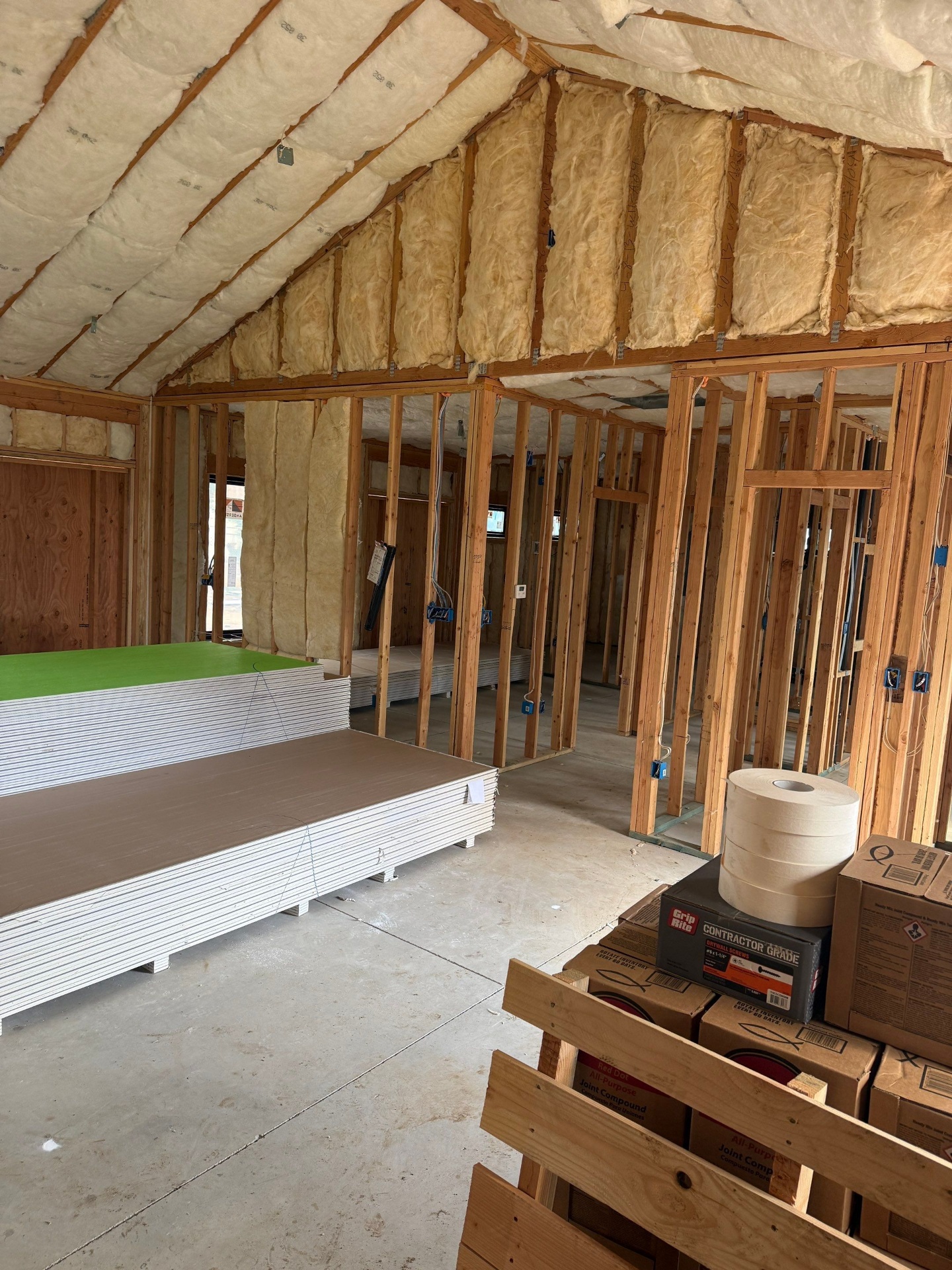 Insulation installed and drywall staged for hang